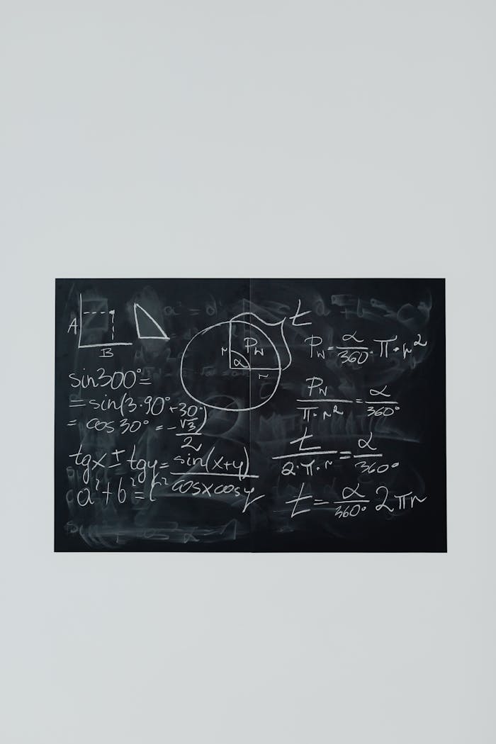 Blackboard filled with chalk math formulas and geometry diagrams, ideal for educational themes.